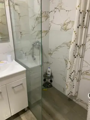 a bathroom with a shower with a glass door at Apartman SA&BO in Podgorica