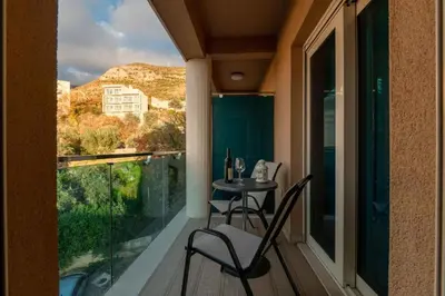 a balcony with a table and chairs and a view at Obrad Pržno See View in Kamenovo