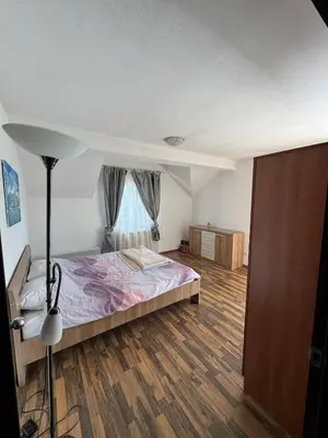 a bedroom with a bed and a lamp in a room at Duplex apartment in Podgorica in Podgorica