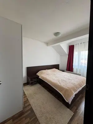 a bedroom with a large bed and a window at Duplex apartment in Podgorica in Podgorica
