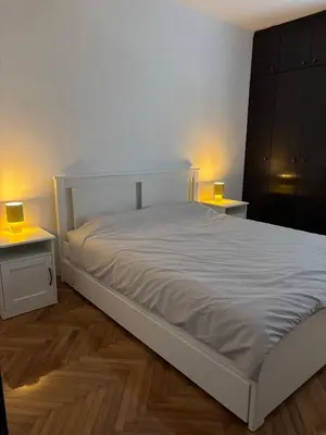 a white bed in a room with two tables at Stay In Bar in Bar
