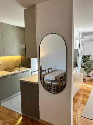 a kitchen and dining room with a mirror on the wall at Stay In Bar in Bar