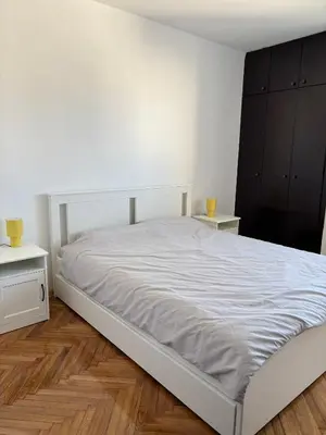 a bedroom with a white bed and two night stands at Stay In Bar in Bar