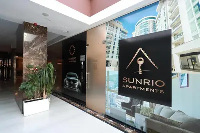 a sign for a sunocoagents store in a building at Sunrio Apartments in Budva