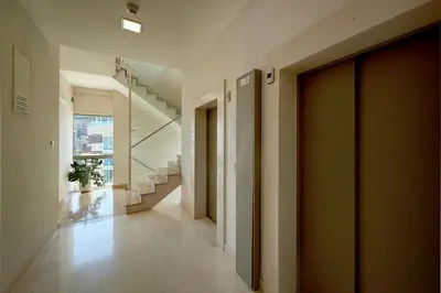 a hallway with stairs and a door in a building at Sunrio Apartments in Budva