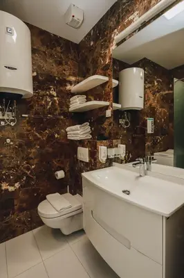 a bathroom with a sink and a toilet and a mirror at Sunrio Apartments in Budva