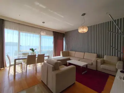 a living room with a couch and a table at Sunrio Apartments in Budva