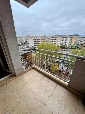 a balcony with a view of a city at Bright & Cozy Urban Apartment in Podgorica