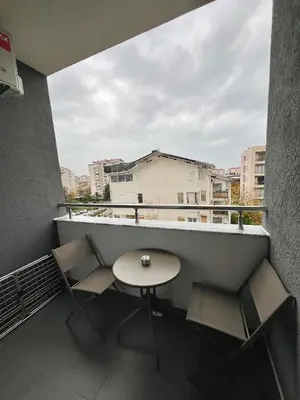 a balcony with a table and chairs on a building at Family Homes Bar Apartment in Bar