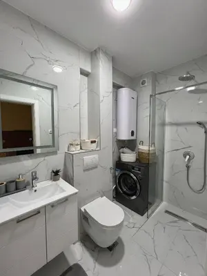 a bathroom with a toilet and a sink and a shower at Family Homes Bar Apartment in Bar