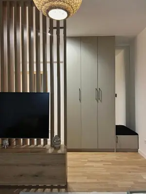 a living room with a flat screen tv and a chandelier at Family Homes Bar Apartment in Bar