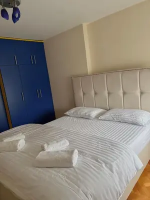 a bedroom with a bed with two towels on it at Milenijum apartman in Podgorica