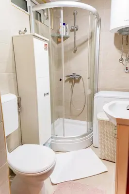 a bathroom with a shower and a toilet and a sink at Milenijum apartman in Podgorica