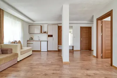 a living room with a couch and a kitchen at Aqua Lounge Aparthotel Ulcinj in Ulcinj