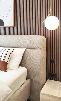 a bedroom with a bed and a lamp and a chair at Stylish City Living Elegant One Bedroom Apartment in Podgorica