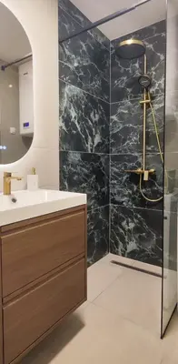 a bathroom with a sink and a shower at Stylish City Living Elegant One Bedroom Apartment in Podgorica