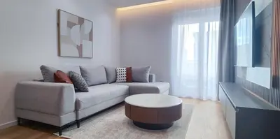 a living room with a couch and a table at Stylish City Living Elegant One Bedroom Apartment in Podgorica