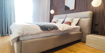a bedroom with a large bed with pillows on it at Stylish City Living Elegant One Bedroom Apartment in Podgorica