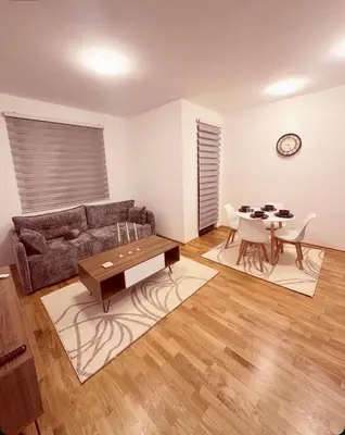a living room with a couch and a table at Apartman 2937 in Podgorica