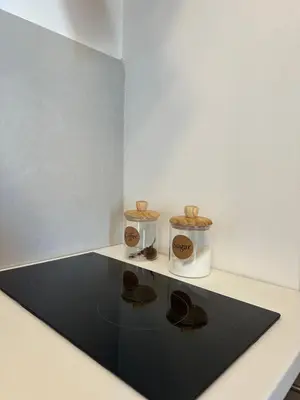 two containers sitting on a table with a black rug at Apartman 2937 in Podgorica