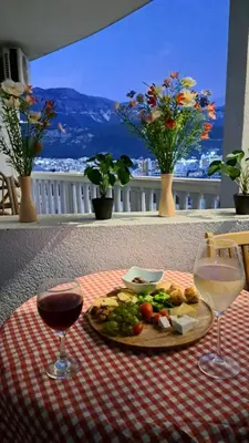 a table with a plate of food and two glasses of wine at Sheldon in Budva