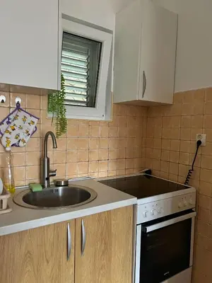 a kitchen with a sink and a window at Sheldon in Budva