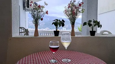 two glasses of wine sitting on a table with a window at Sheldon in Budva