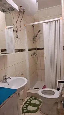 a bathroom with a sink and a toilet and a shower at Sheldon in Budva