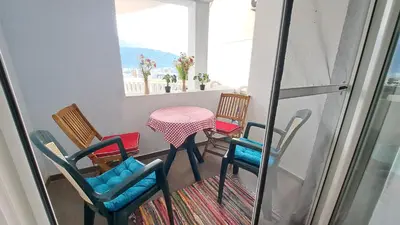 a balcony with chairs and a table and a table at Sheldon in Budva