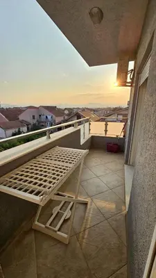 a bed sitting on the ledge of a balcony at OldAirport in Podgorica