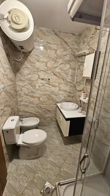 a bathroom with two toilets and a sink at OldAirport in Podgorica