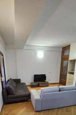 a living room with a couch and a tv at OldAirport in Podgorica