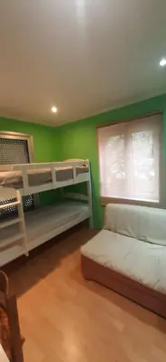 a bedroom with two bunk beds and a window at Zlatna Guest House in Kotor