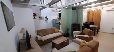 a living room with two couches and a table at Zlatna Guest House in Kotor
