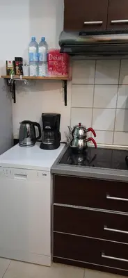 a kitchen with a stove and a tea kettle on it at Zlatna Guest House in Kotor