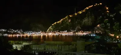 a view of a city at night with a mountain at Zlatna Guest House in Kotor