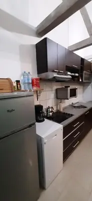 a kitchen with a refrigerator and a stove at Zlatna Guest House in Kotor