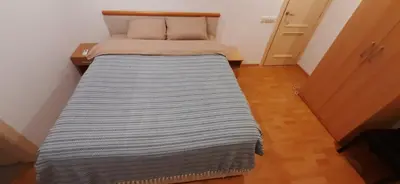 a large bed in a small room with aedes at Zlatna Guest House in Kotor