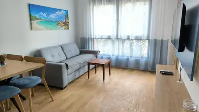 a living room with a couch and a table at Apartments LORA Novi Bar in Bar