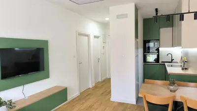 a kitchen and dining room with green and white walls at Apartments LORA Novi Bar in Bar