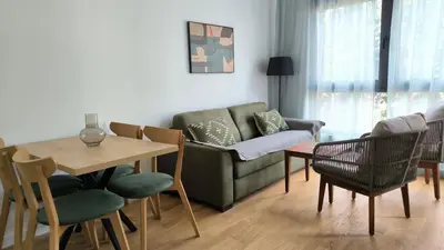 a living room with a couch and a table and chairs at Apartments LORA Novi Bar in Bar