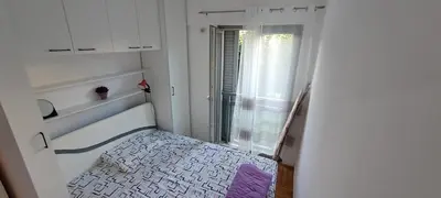 a small room with a balcony with a purple rug at Nikola apartment in Podgorica