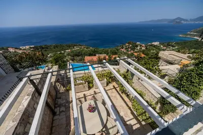 a view of the ocean from the balcony of a house at Olive Resort in Petrovac na Moru