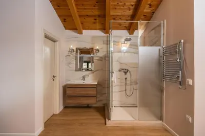 a bathroom with a glass shower and a sink at Olive Resort in Petrovac na Moru