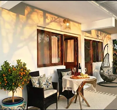 a patio with a table and chairs and a window at Beach House Kruče in Ulcinj