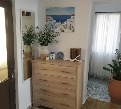 a dresser with plants on top of it in a room at Beach House Kruče in Ulcinj