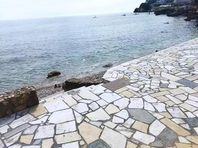 a stone walkway next to the water at Beach House Kruče in Ulcinj