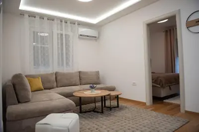 a living room with a couch and a table at Phenix Apartments Parking FREE in Podgorica