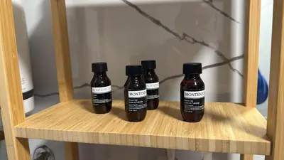 four bottles of sauce sitting on a shelf at Phenix Apartments Parking FREE in Podgorica