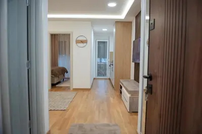 a hallway with a room with a bed and a door at Phenix Apartments Parking FREE in Podgorica